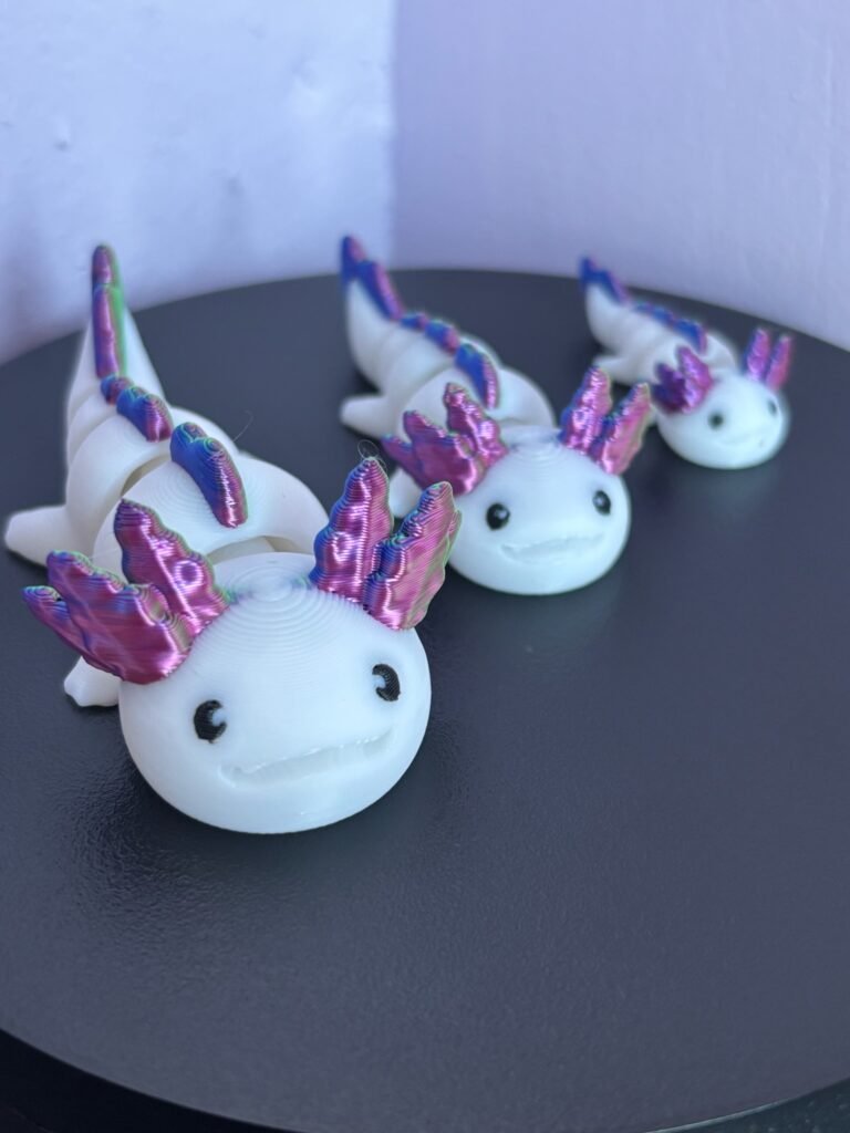 Pastel pink articulated axolotl fidget toy, 3D printed in PLA