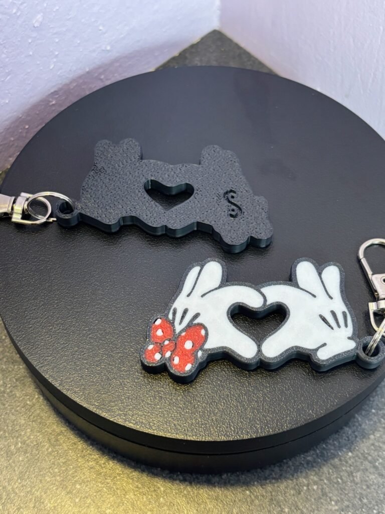 Mickey and Minnie-style 3D printed hand heart keyrings in white PLA with bow and heart detail variations