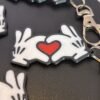 Mickey and Minnie-style 3D printed hand heart keyrings in white PLA with bow and heart detail variations