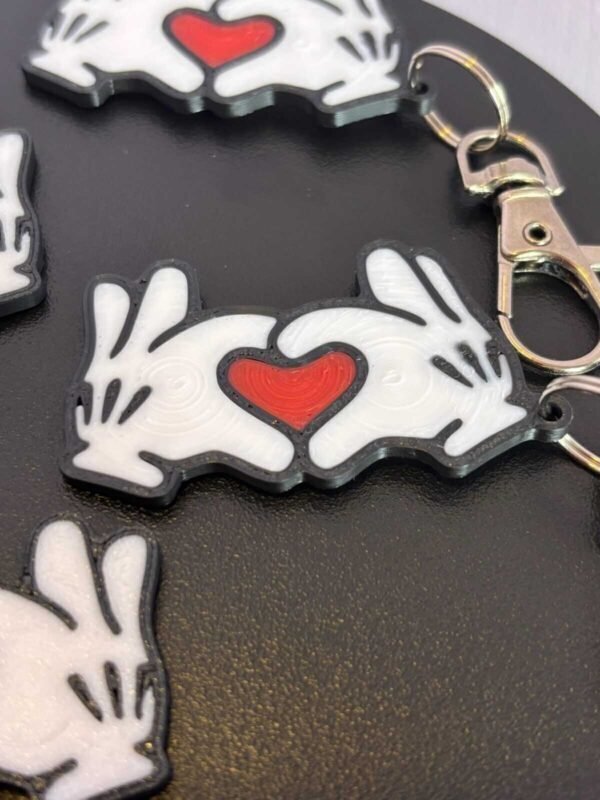 Mickey and Minnie-style 3D printed hand heart keyrings in white PLA with bow and heart detail variations