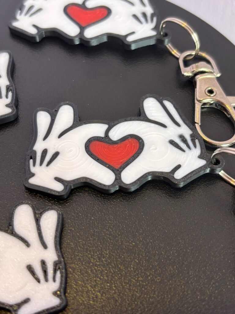 Mickey and Minnie-style 3D printed hand heart keyrings in white PLA with bow and heart detail variations