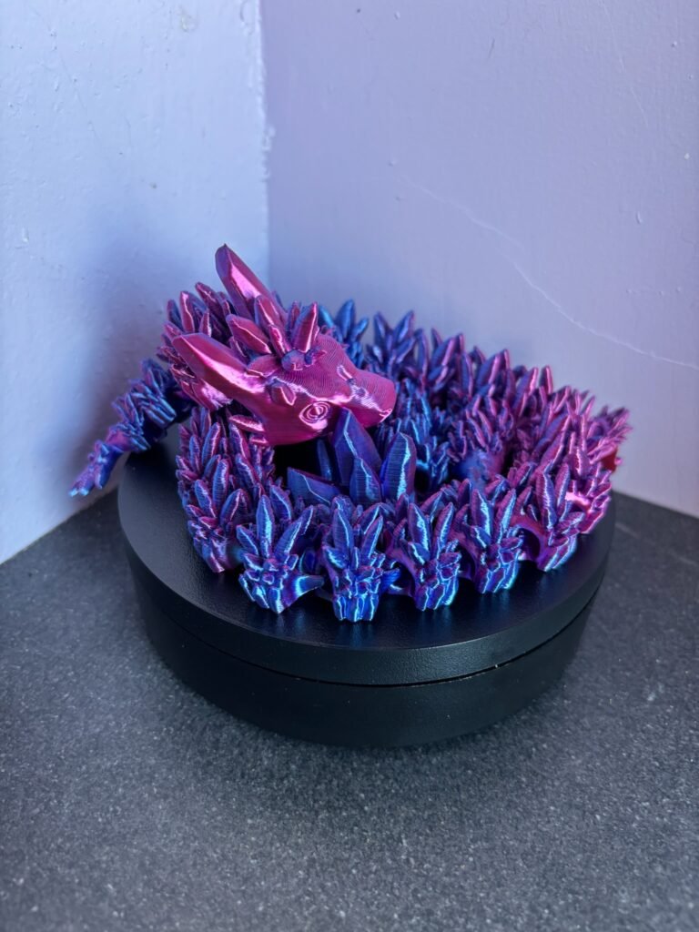 Articulated crystal dragon fidget toy in shimmering blue, 3D printed in PLA