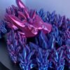 Articulated crystal dragon fidget toy in shimmering blue, 3D printed in PLA