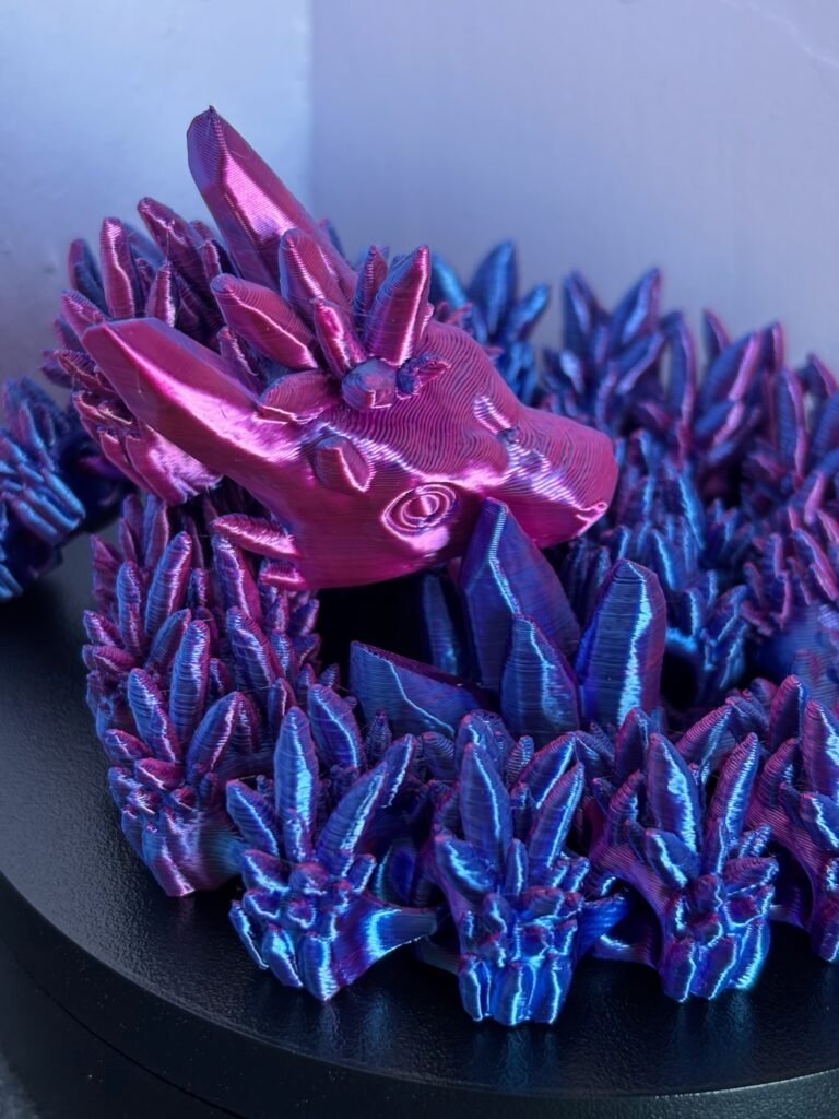 Articulated crystal dragon fidget toy in shimmering blue, 3D printed in PLA