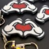 Mickey and Minnie-style 3D printed hand heart keyrings in white PLA with bow and heart detail variations