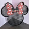3D printed Minnie pin board with bow design in black and red PLA for displaying enamel pins