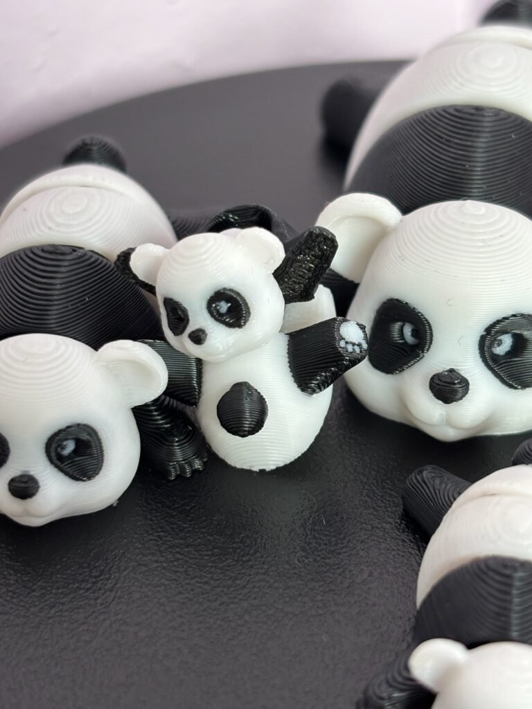 Black and white articulated panda fidget toy, 3D printed in PLA