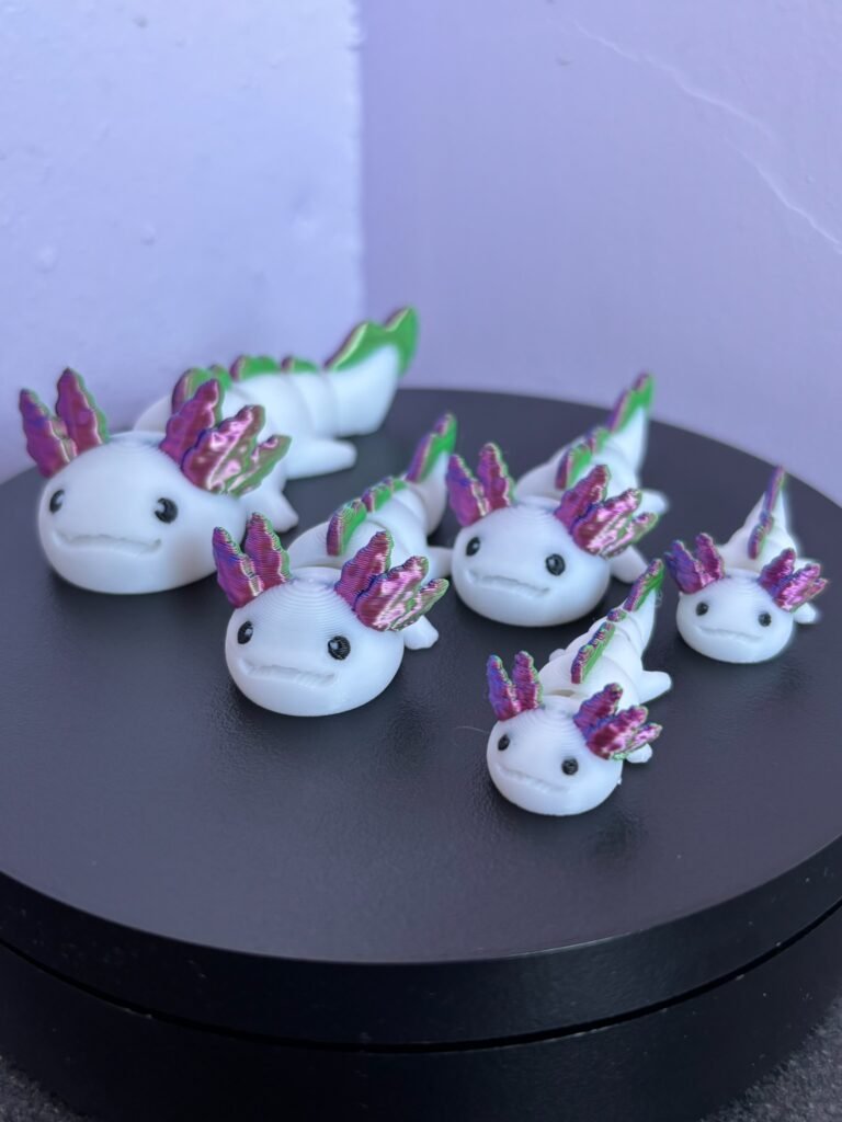 Pastel pink articulated axolotl fidget toy, 3D printed in PLA