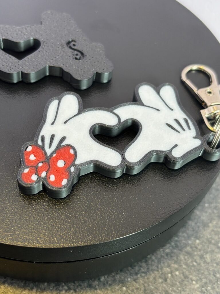 Mickey and Minnie-style 3D printed hand heart keyrings in white PLA with bow and heart detail variations