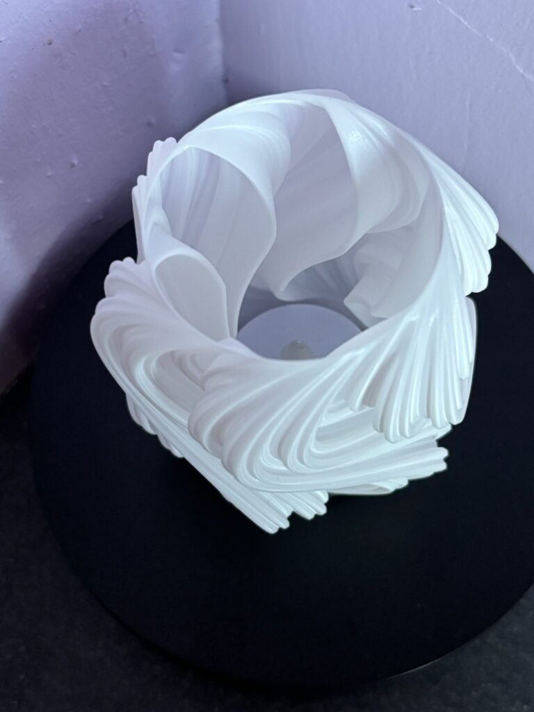 Modern swirl tea light holder with artificial candle