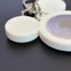 Front-facing white mouse-ear AirTag bag charm with attached metal clasp