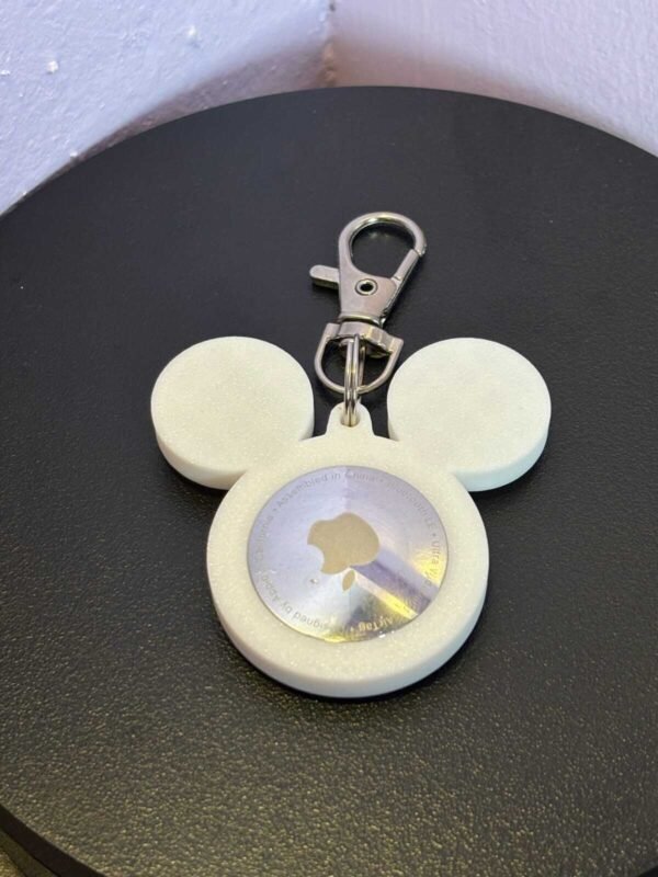 Front-facing white mouse-ear AirTag bag charm with attached metal clasp