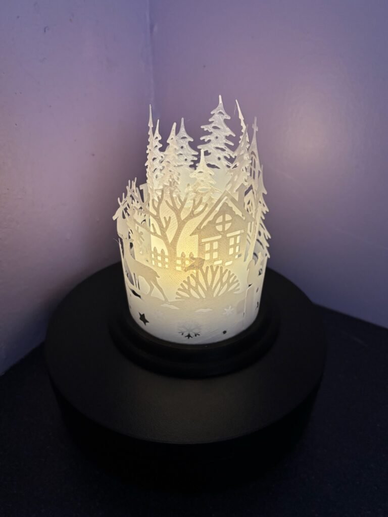 Christmas snow scene lantern glowing with flicker candle