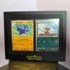Black 3D-printed Pokémon card display frame holding two sleeved cards