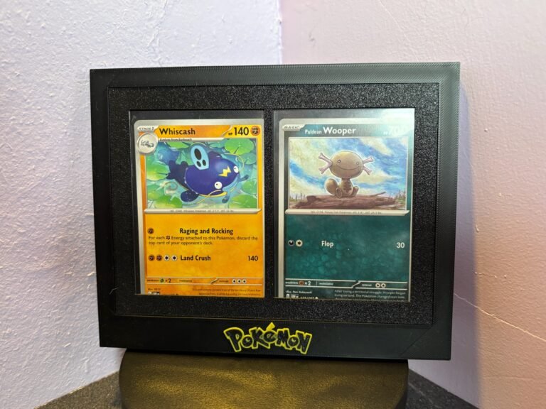 Black 3D-printed Pokémon card display frame holding two sleeved cards