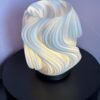 3D printed swirl tea light lantern glowing with flicker candle
