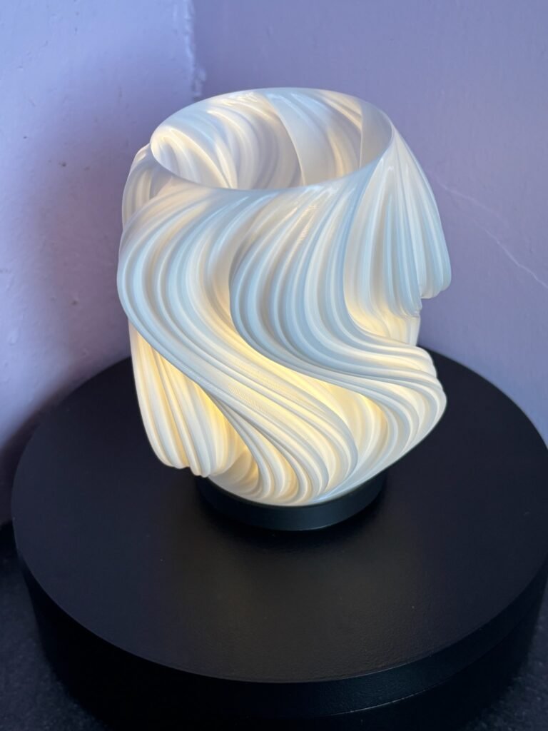 3D printed swirl tea light lantern glowing with flicker candle