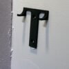 Small black wall hook for Formula 1 car display