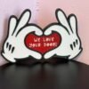 Magical cruise door gift decoration — 3D printed cartoon white gloved hands forming a heart with red centre reading "We Love Your Door!", black outline, UK made fish extender gift