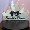 Personalised magical castle room sign reading "Sophia's Room" — white 3D printed fairytale castle silhouette with enchanted mouse couple motif and storybook font