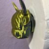 Detail shot of gold silk PLA highland cow head with horns and shaggy fringe on novelty 3D printed toilet roll holder, UK made