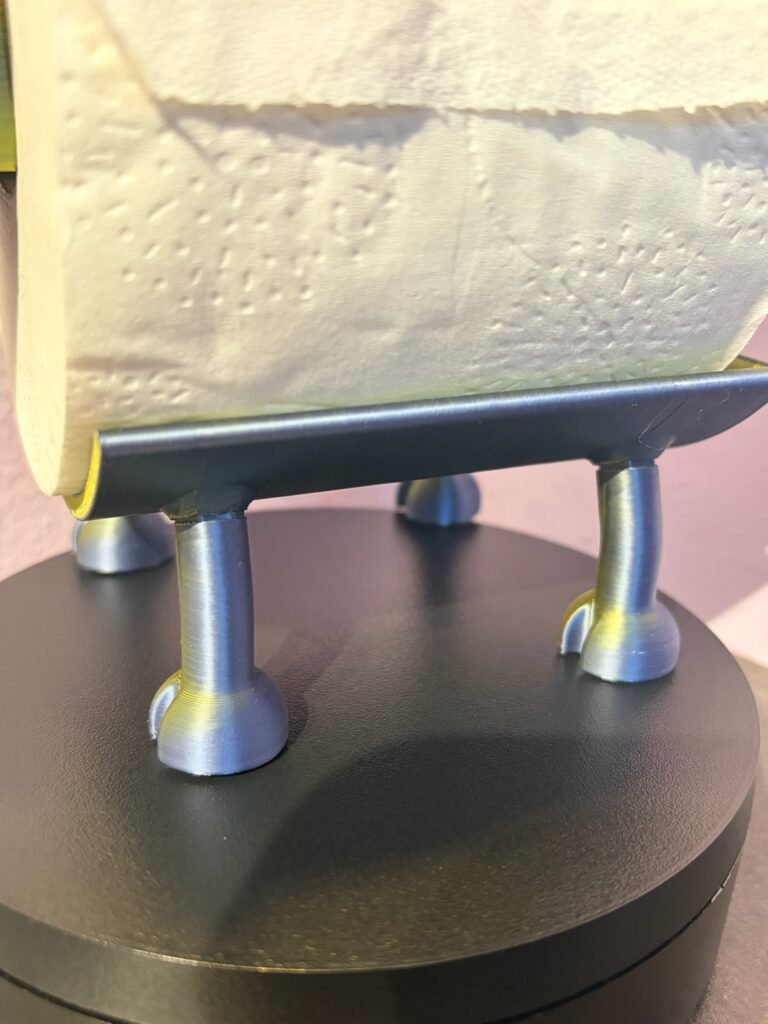 Close-up of hooved legs on 3D printed highland cow toilet roll holder — sturdy freestanding base designed for bathroom shelves and windowsills