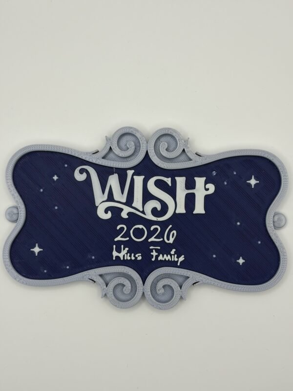 Personalised magical cruise ship name door plaque — navy blue starry night background with silver ornate scroll frame, showing "Wish 2026 Hills Family" in white raised text, UK 3D printed cruise magnet