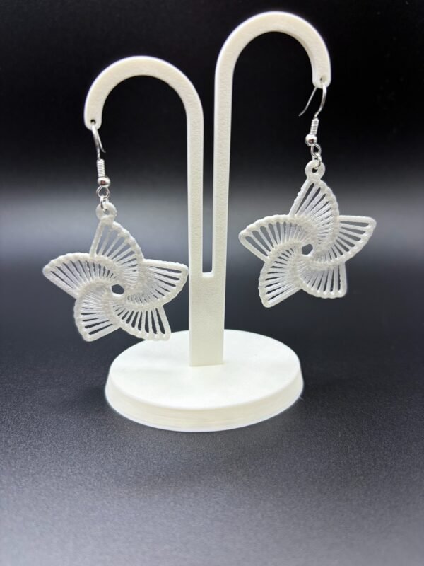 Pair of white star radial dangle earrings on display stand - 3D printed celestial jewellery by HulkyWears UK