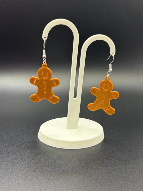 Pair of gingerbread man dangle earrings on display stand - 3D printed EcoPlastic festive Christmas jewellery by HulkyWears UK