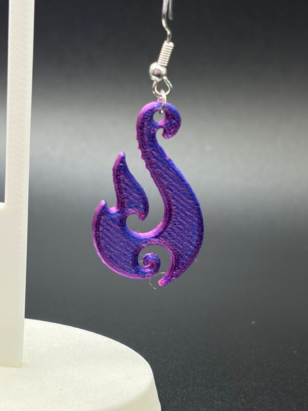 Close-up of purple-blue silk flame swirl dangle earring showing colour shift and flowing silhouette detail - HulkyWears UK