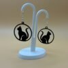 Pair of black sitting cat silhouette disc dangle earrings on display stand - 3D printed EcoPlastic jewellery by HulkyWears UK