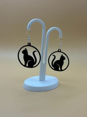 Pair of black sitting cat silhouette disc dangle earrings on display stand - 3D printed EcoPlastic jewellery by HulkyWears UK
