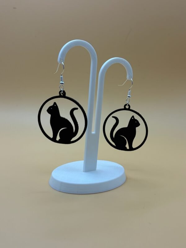 Pair of black sitting cat silhouette disc dangle earrings on display stand - 3D printed EcoPlastic jewellery by HulkyWears UK