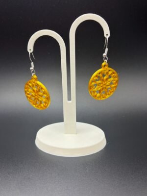 Pair of gold snowflake disc dangle earrings on display stand - 3D printed festive jewellery by HulkyWears UK