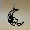 Close-up of black crescent moon dangle earring showing filigree heart and star cutout detail - HulkyWears 3D printed jewellery UK