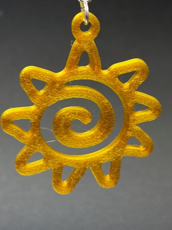 Pair of golden yellow spiral sun dangle earrings on display stand - 3D printed boho jewellery by HulkyWears UK