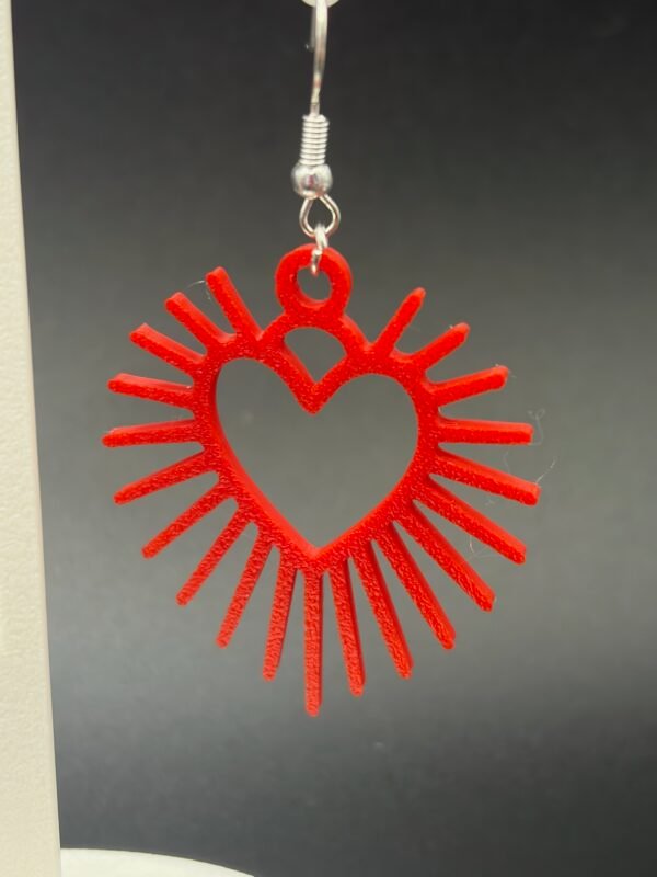 Red sunburst heart dangle earring close-up with silver hypoallergenic hook - 3D printed EcoPlastic jewellery by HulkyWears