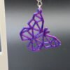 Close-up of purple-blue silk geometric butterfly dangle earring showing low-poly faceted design and colour shift - HulkyWears 3D printed jewellery