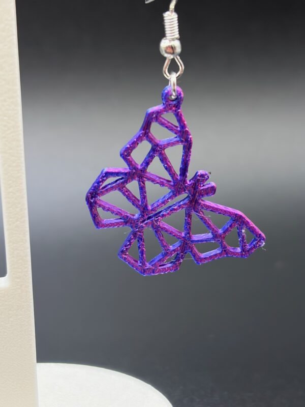 Close-up of purple-blue silk geometric butterfly dangle earring showing low-poly faceted design and colour shift - HulkyWears 3D printed jewellery