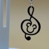 Close-up of black Mickey treble clef dangle earring with Mickey silhouette in clef body - HulkyWears 3D printed jewellery UK