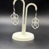Pair of white goddess figure dangle earrings on display stand - 3D printed spiritual EcoPlastic jewellery by HulkyWears UK