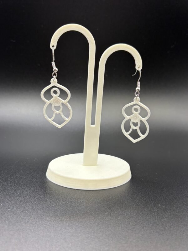 Pair of white goddess figure dangle earrings on display stand - 3D printed spiritual EcoPlastic jewellery by HulkyWears UK