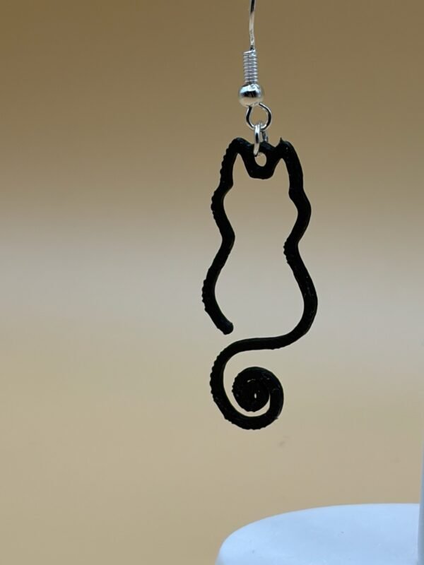 Close-up of black open cat silhouette dangle earring with curled spiral tail and silver hypoallergenic hook - HulkyWears 3D printed jewellery