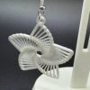 Close-up of white frosted star radial dangle earring showing open line cutout pattern - 3D printed EcoPlastic jewellery by HulkyWears