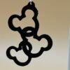 Close-up of black interlocking Mickey head cluster dangle earring showing repeating round ear silhouette pattern - HulkyWears UK