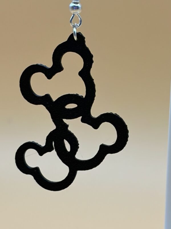 Close-up of black interlocking Mickey head cluster dangle earring showing repeating round ear silhouette pattern - HulkyWears UK