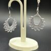 Pair of silver white mandala hoop dangle earrings on display stand - 3D printed EcoPlastic boho jewellery by HulkyWears UK