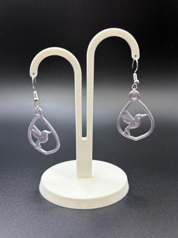 Pair of lilac hummingbird teardrop dangle earrings on display stand - 3D printed EcoPlastic nature jewellery by HulkyWears UK