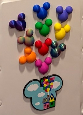 up house & balloons Rainbow Mickey balloon magnets arranged like the Up house balloons on a magnetic surface with a small Up house Mickey magnet below