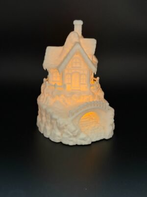 img 9478 Front view of winter cottage tea light holder – white Christmas village house with icicle roof, picket fence and glowing windows